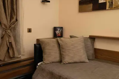a bedroom with a bed with pillows and a window at Apartman W Residence in Kopaonik