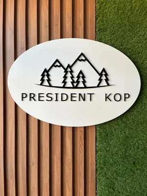 a sign that reads president top on a wood wall at President Kop Fibi in Kopaonik