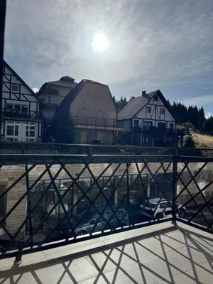 a bridge over a body of water with houses at President Kop Fibi in Kopaonik