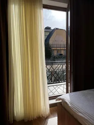 a bedroom with a window with a view of a building at President Kop Fibi in Kopaonik