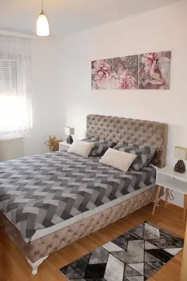 a bedroom with a large bed in a room at Miss apartman in Jagodina