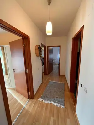 a room with a hallway with a door and a rug at Miss apartman in Jagodina