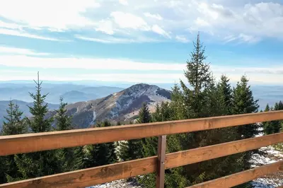 a wooden fence with a view of a mountain at Vila Kruna Sunčani Breg in Kopaonik