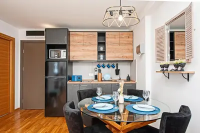 a kitchen and dining room with a table and chairs at Apt. Kop for you in Kopaonik