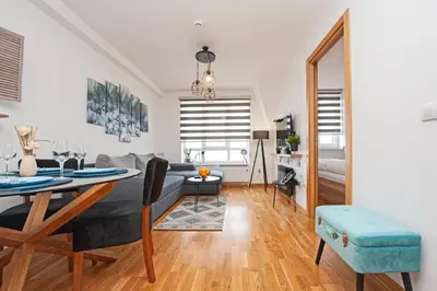 a living room with a table and a couch at Apt. Kop for you in Kopaonik