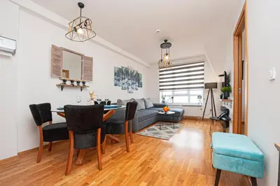 a living room with a table and a couch at Apt. Kop for you in Kopaonik