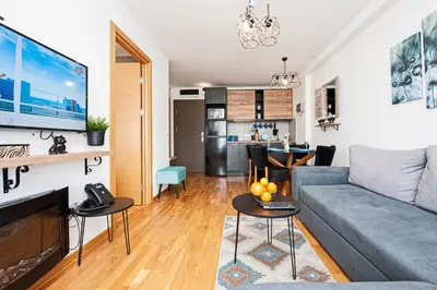a living room with a couch and a table at Apt. Kop for you in Kopaonik