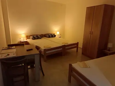 a bedroom with a bed and a table and a desk at Adamovic in Pirot
