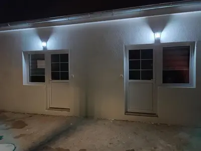 an empty room with two doors and lights at Adamovic in Pirot