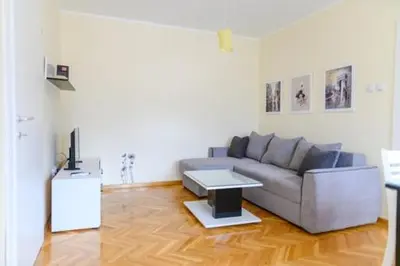 a living room with a couch and a table at Apartman Ivanka in Soko Banja