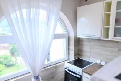 a kitchen with a window and a sink and a stove at Apartman Ivanka in Soko Banja