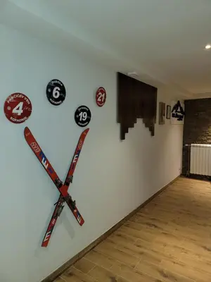 a wall with two hockey sticks on a wall at MASSIV Kopaonik centar lux apartmani in Kopaonik