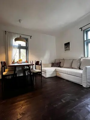 a living room with a white couch and a table at Sentina kuća in Vrtovac