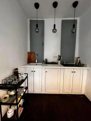 a kitchen with white cabinets and a sink at Sentina kuća in Vrtovac