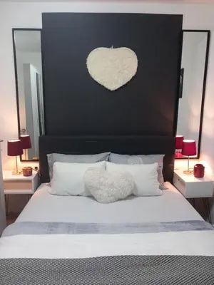 a bedroom with a large bed with a heart on the headboard at Viva Lux in Soko Banja