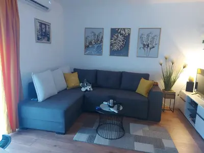 a blue couch in a living room with a table at Viva Lux in Soko Banja