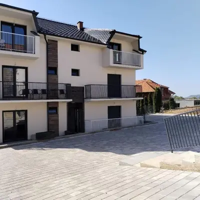 a large white building with balconies and a patio at Viva Lux in Soko Banja