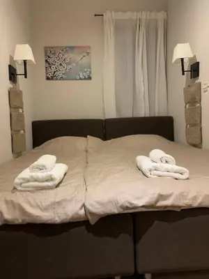 a bed with two towels on top of it at Apartment Župa 111 - Župa, Kopaonik in Kopaonik