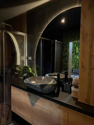 a bathroom with a large stone sink on a counter at Beta Lux in Zaječar