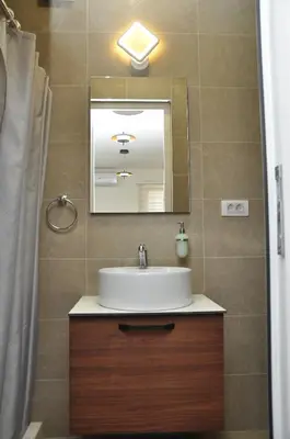 a bathroom with a sink and a mirror at Nego apartmani in Kuršumlija