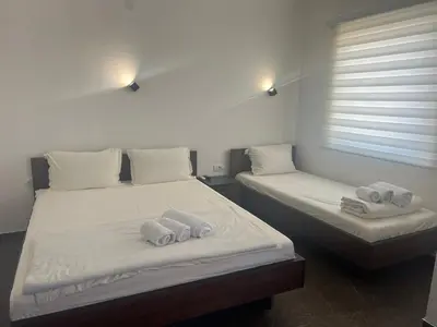 two beds in a room with towels on them at Nego apartmani in Kuršumlija