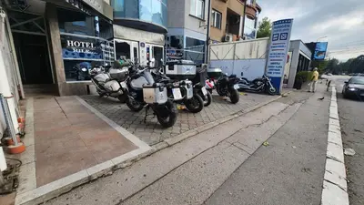 a row of motorcycles parked in front of a store at Hotel Rile Men Blue in Niš