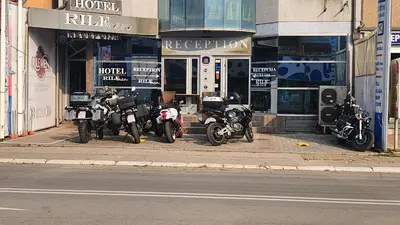 a group of motorcycles parked in front of a building at Hotel Rile Men Blue in Niš