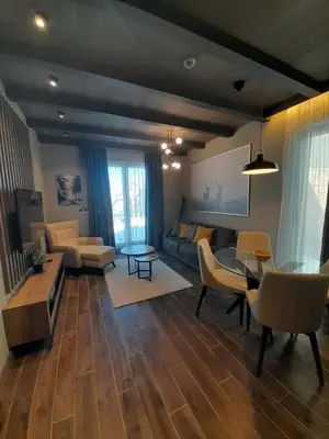 a living room with a couch and a table at Woodside RENT Kopaonik in Kopaonik