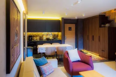 a living room with a couch and a table at Woodside RENT Kopaonik in Kopaonik