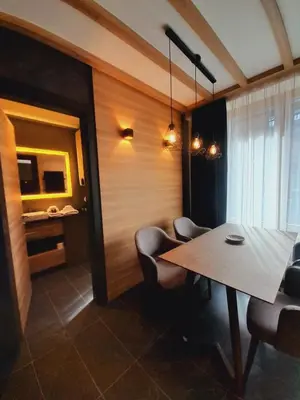 a dining room with a table and chairs at Woodside RENT Kopaonik in Kopaonik
