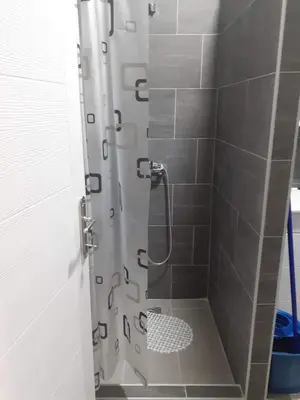 a bathroom with a shower with a glass door at Apartman Leggiero in Vrnjačka Banja