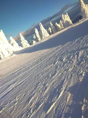a snow covered slope with footprints in the snow at Ski hotel DOBRODOLAC in Kopaonik