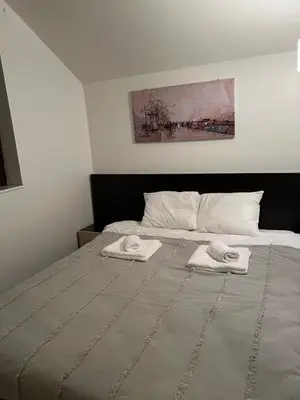 a bedroom with a bed with two towels on it at Apartman Treska Kop in Kopaonik