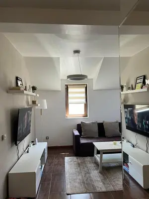 a living room with a couch and a table at Apartman Treska Kop in Kopaonik