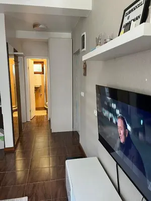 a living room with a flat screen tv on a wall at Apartman Treska Kop in Kopaonik
