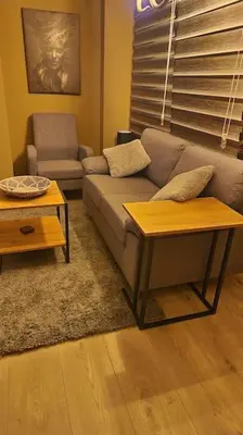 a living room with a couch and a table at Supreme studio in Niš