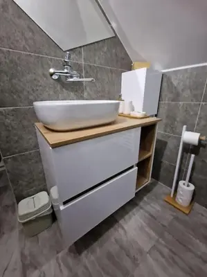 a bathroom with a sink and a mirror at Supreme studio in Niš