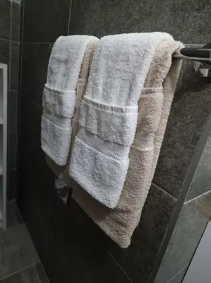 a towel hanging on a towel rack in a bathroom at Supreme studio in Niš
