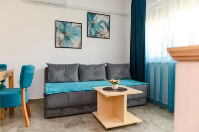 a living room with a couch and a table at Apartmani Djukic in Soko Banja