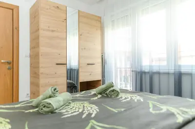 a bedroom with a bed with towels on it at Apartmani Djukic in Soko Banja