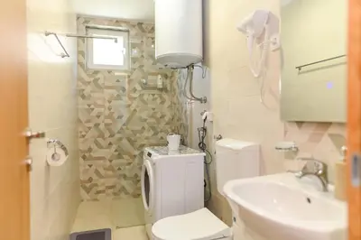 a small bathroom with a toilet and a sink at Apartmani Djukic in Soko Banja