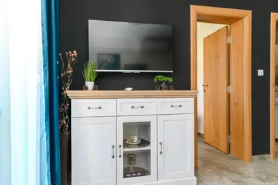 a white cabinet with a television on top of it at Apartmani Djukic in Soko Banja