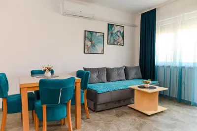 a living room with a couch and a table at Apartmani Djukic in Soko Banja
