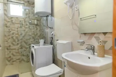 a bathroom with a toilet and a sink at Apartmani Djukic in Soko Banja