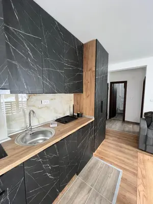 a kitchen with a sink and a counter top at Apartments SKY Kopaonik in Kopaonik
