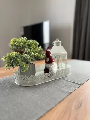 a plate with a santa claus and two trees on a table at Apartments SKY Kopaonik in Kopaonik