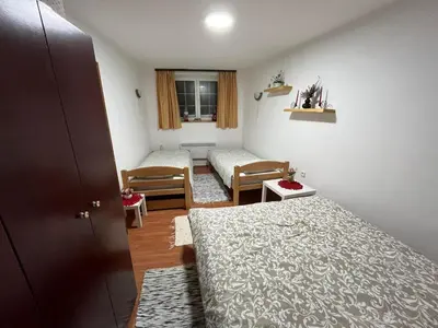 a small room with two beds and a window at Apartman Cogan - 100m from Gondola - Brzece in Kopaonik