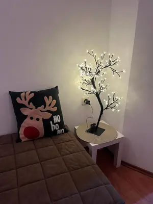 a bedroom with a bed and a tree with a no horns pillow at Apartman Cogan - 100m from Gondola - Brzece in Kopaonik