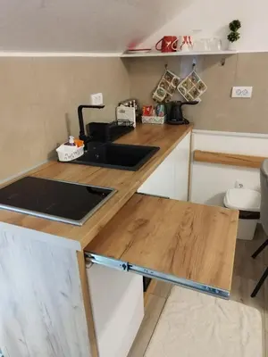 a small kitchen with a sink and a counter at Apartman Rajčić in Vrnjačka Banja