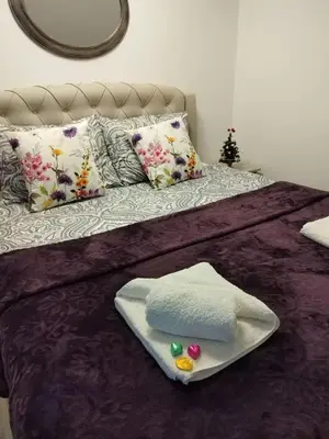 a bed with a tray with towels on it at Apartman Rajčić in Vrnjačka Banja
